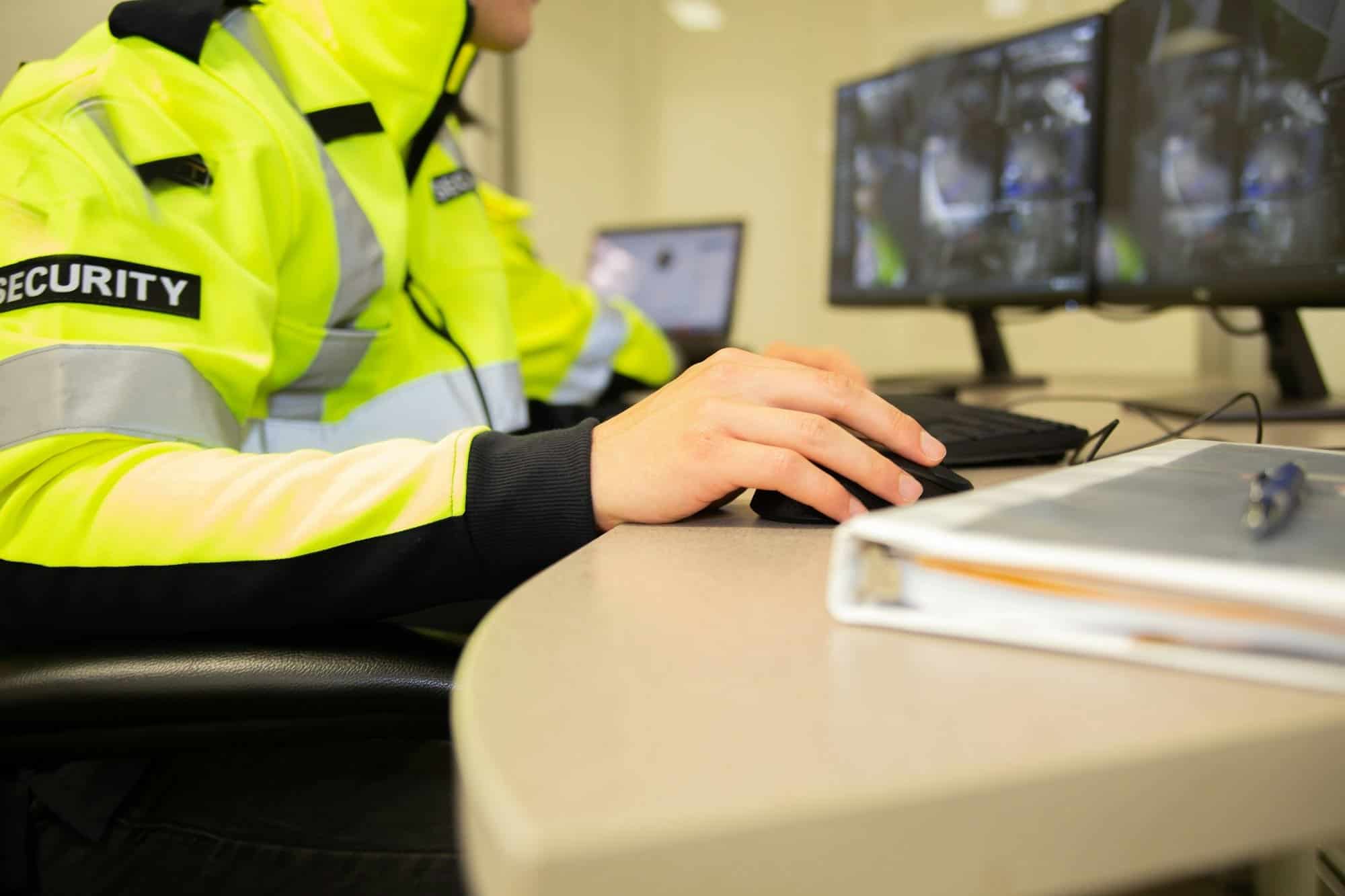 Security team watching over CCTV surveillance monitors.